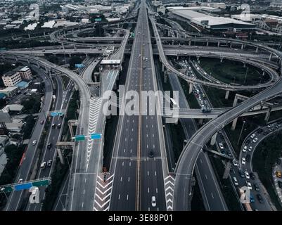 Highangle view of a complex concrete highway interchange with interconnected flyovers and expressways in a modern urban landscape. Stock Photo