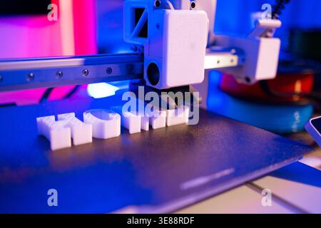 3D Printer Creating White Letters Stock Photo