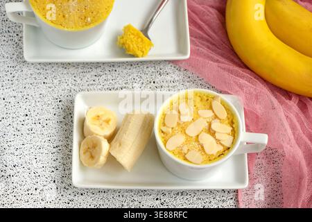 mini cake. Breakfast in a mug. homemade Portioned Banana mugcake in small mugs. Stock Photo