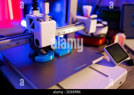3D Printer Creating Blue Objects Stock Photo