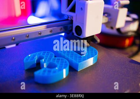 3D Printer Creating Blue Objects Stock Photo