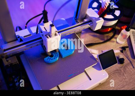 3D Printer Creating Blue Letters Stock Photo