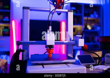 3D Printer Creating Orange Object Stock Photo