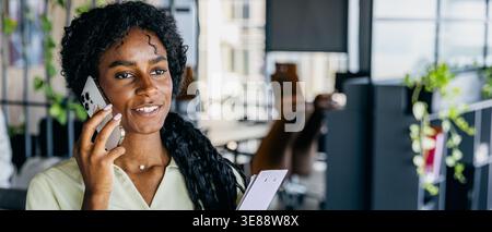 Person working at desk with digital charts and natural light Stock Photo
