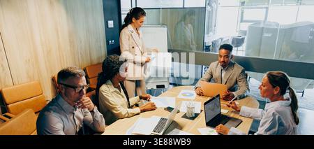 Inclusive team engaging in collaborative problem solving Stock Photo