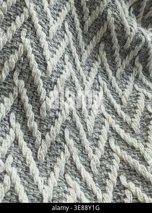 Herringbone knit pattern background with textured gray and white yarn creating zigzag design. Mobile photo Stock Photo