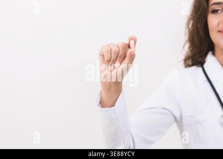Doctor hand showing pill on white background Stock Photo