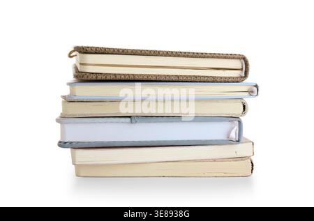 Stack of many different notebooks isolated on white background Stock Photo