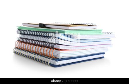 Stack of many different notebooks isolated on white background Stock Photo