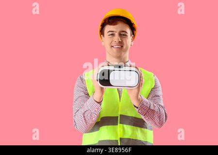 Male worker with VR glasses on pink background Stock Photo