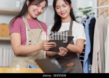 Entrepreneurs reviewing business data on tablet Stock Photo