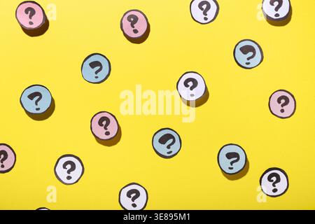 Different question marks on yellow background Stock Photo