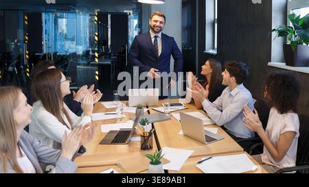 Business team applauding to leader, congratulating with project Stock Photo