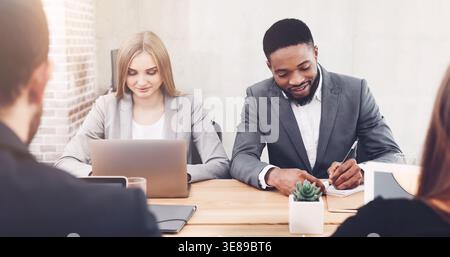 Managers working in office, using laptop and writing ideas Stock Photo
