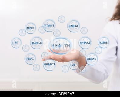 Doctor points at health caring icon with other medical signs Stock Photo