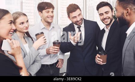 Team having small talk at their coffee break Stock Photo