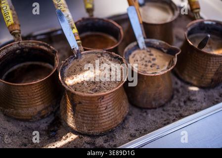 Traditional Turkish Coffee Brewing in Copper Cezve on Sand. High quality photo Stock Photo