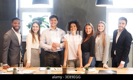 Young business team smiling to camera, having break Stock Photo