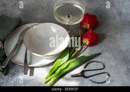 Table setting with beautiful red tulips Stock Photo