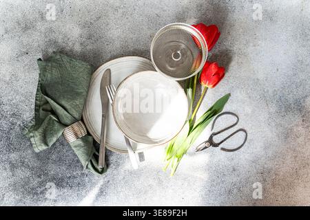 Table setting with beautiful red tulips Stock Photo
