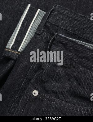 Dark denim jeans texture close-up fabric background Stock Photo
