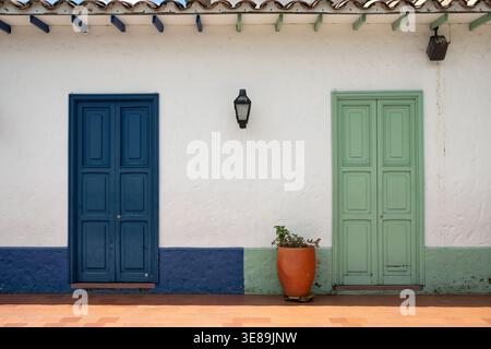 Traditional Colonial House With Vibrant Painted Doors In Medellin Antioquia Colombia Stock Photo