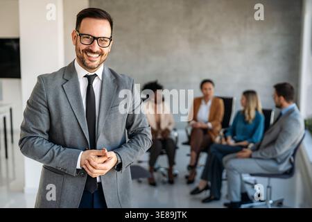 Multicultural professional businesspeople working together on research plan in boardroom. Stock Photo