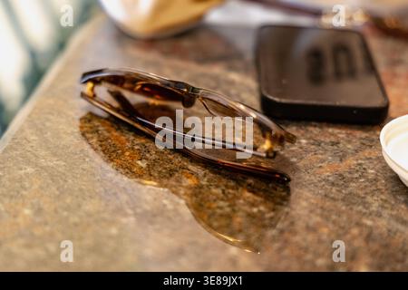 Folded Tortoise Shell Glasses Beside Smartphone Stock Photo