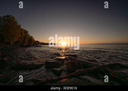 Golden hour light reflecting on lake water and shore Silver City Stock Photo