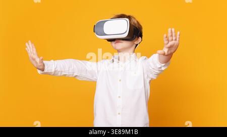 Preteen boy using virtual reality headset and gesturing Stock Photo