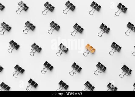 Binder Clips Are Arranged in a Pattern on a White Surface Stock Photo