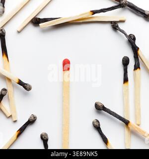 Collection of Matchsticks in Different States on a White Surface Stock Photo