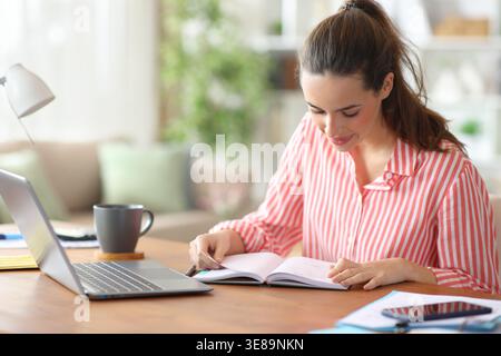 Self employed consulting appointment in paper agenda working at home Stock Photo