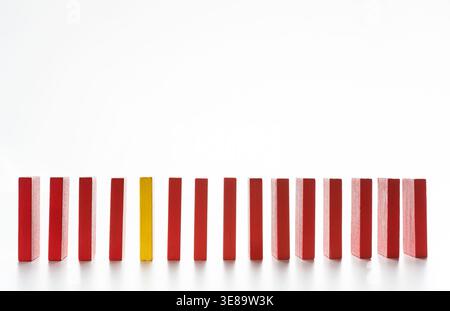 Collection of Red and Yellow Blocks Arranged in a Straight Line and Ready to Fall in a Sequence Stock Photo