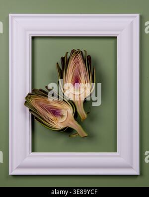 Fresh artichokes are cut in half and displayed in a frame. Stock Photo
