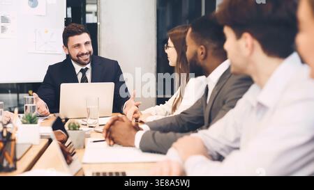 Business people brainstorming together in meeting room Stock Photo