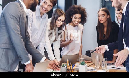 Coworkers analyzing data using computers in office Stock Photo