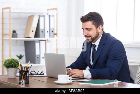 Businessman working on laptop for new architectural project. Stock Photo