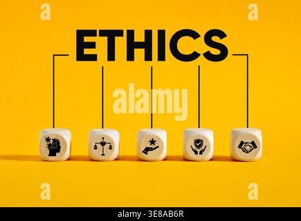 Ethics word connecting to icons on wooden cubes showing values and integrity, corporate social responsibility, business honesty, and professional cond Stock Photo