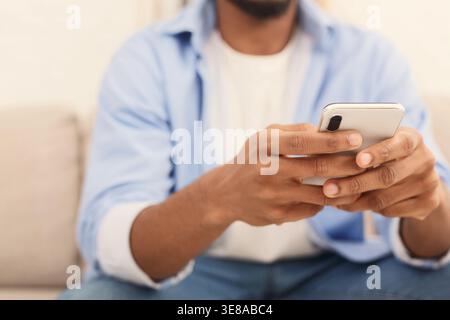 Relaxed casual man using smart phone lying Stock Photo