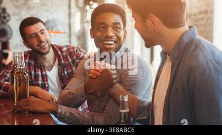 Men Greeting And Shaking Hands In Pub Stock Photo
