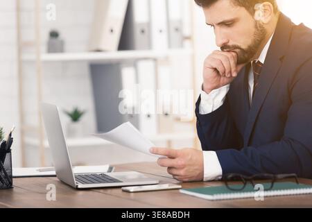 Young finance market analyst working in office Stock Photo