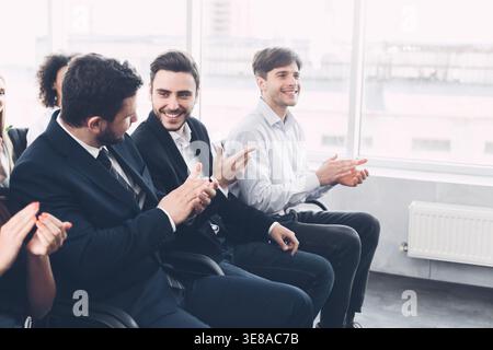 Businessmen discussing something at conference, applauding to speaker Stock Photo