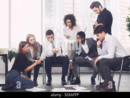 Planning strategy together. Business team looking at papers Stock Photo