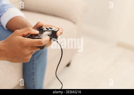 Black man playing video games at home Stock Photo