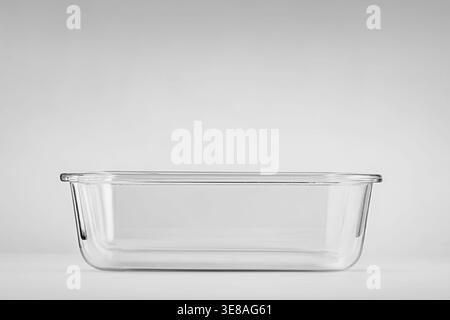A transparent rectangular glass empty container without a lid, designed for storing food or baking on a light gray background. Subject shooting: The s Stock Photo