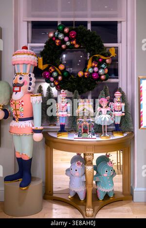Christmas nutcracker figurines and festive decorations on a golden table Stock Photo