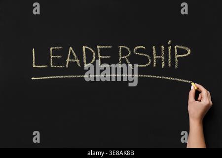 Chalk Writing on a Black Board Showing the Word Leadership With an Underline by a Hand Stock Photo
