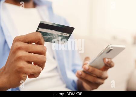 African-american man making transaction using mobile application Stock Photo