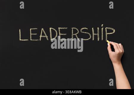 Word Leadership written with white chalk on blackboard Stock Photo